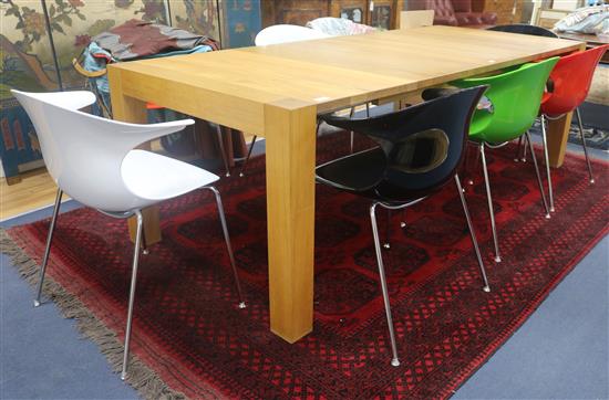 A Heals oiled oak extending dining table and eight various coloured plastic Eames style chairs, W.241cm
